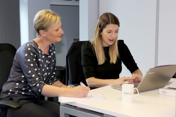 tiggy-and-emma-at-desk-in-torque-law-office