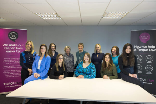 The Torque Law team sit at a table